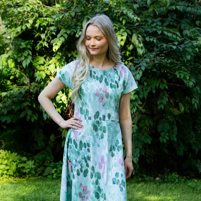 Woman wearing a floral dress standing in a garden