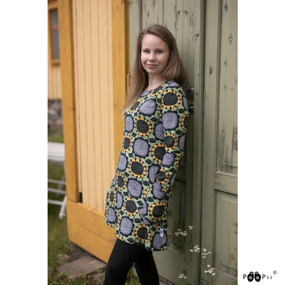 Woman in black pants wearing sunflower tunic with long sleeves