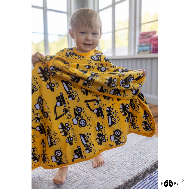 toddler holding yellow machines blanket