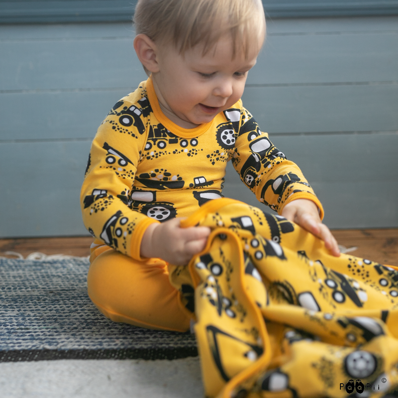 Child picking up organic jersey blanket