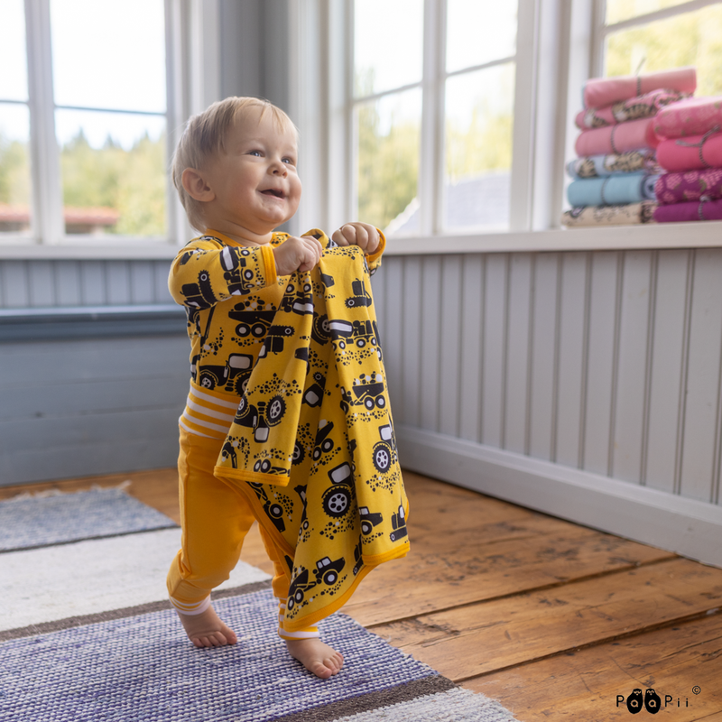 Toddler bringing his baby blanket to mom