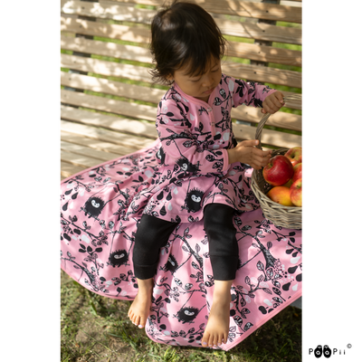 comfy pink baby blanket on park bench