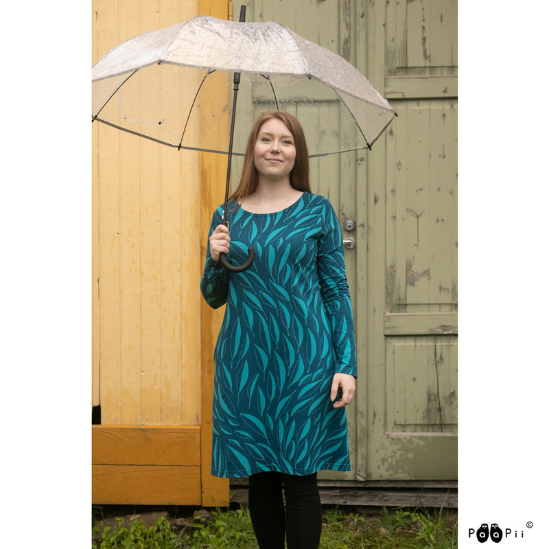 Woman holding umbrella in rain with Sini Dress Flow on