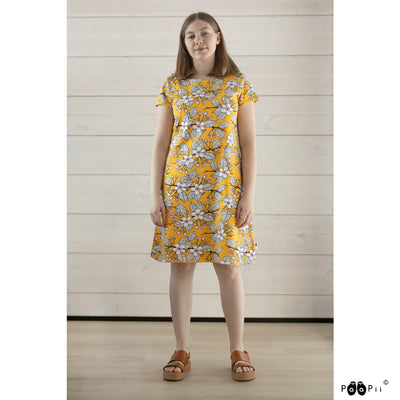 Woman model wearing PaaPii Sointu Dress yellow apple garden with sandals