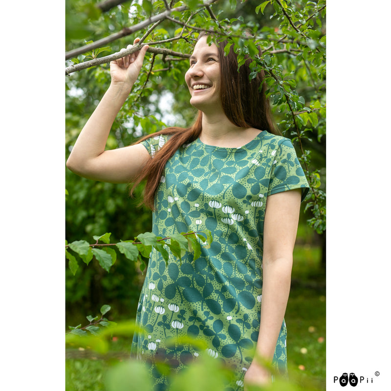 Woman smiling in woods wear green Clover Dress