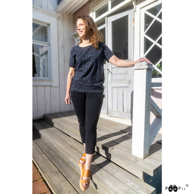 Woman in black pants and tan sandals wearing Tuuli Alvar Shirt