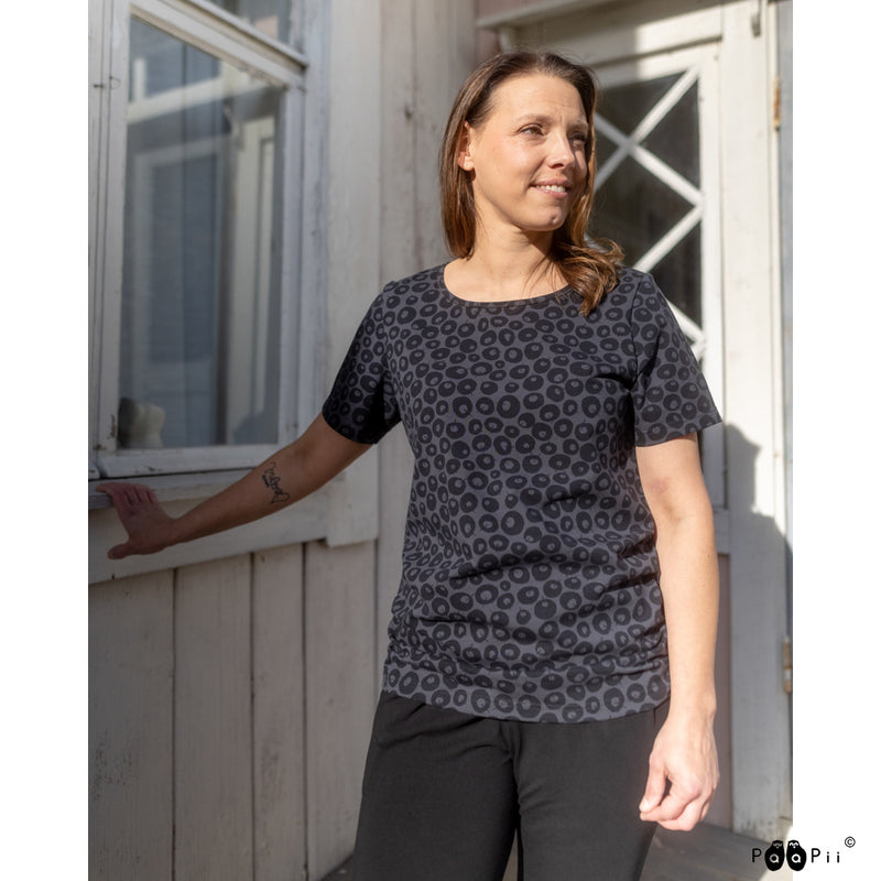 Woman standing on porch wearing black Tuuli Alvar Shirt