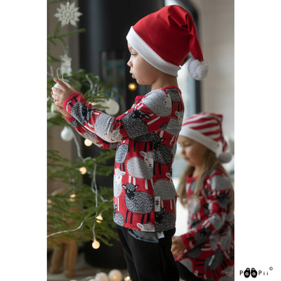 Boy wearing red shirt with Baa design