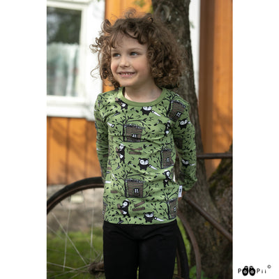 Smiling child wearing PaaPii Uljas Kids Shirt Treehouse