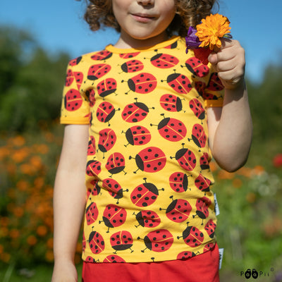 child wearing yellow PaaPii Visa Kids T-Shirt Kerttu