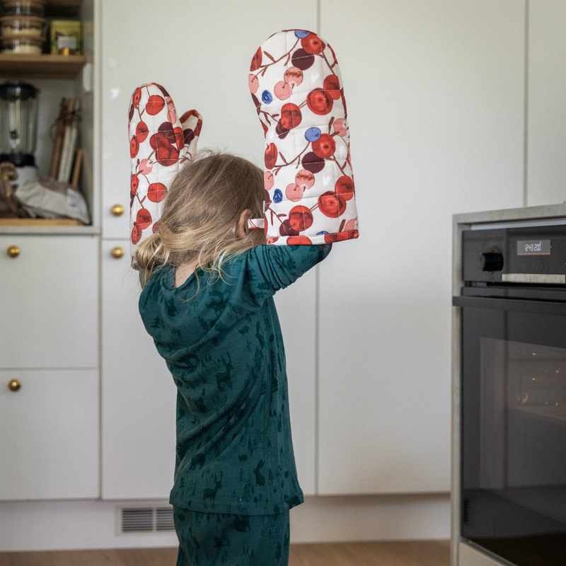 child wearing oversized Pentik Karpalo Oven Mitten