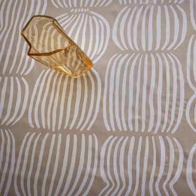 Decorative glass piece on a beige fabric with white abstract patterns