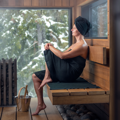 Woman enjoying sauna with Rento Kenno linens