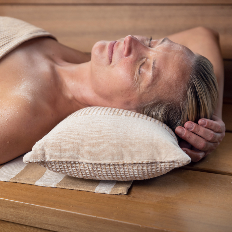 Woman resting on Kenno sauna pillow