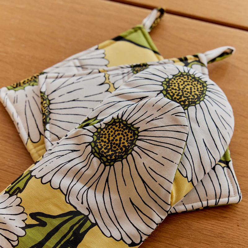 Floral-patterned pot holders on a wooden surface