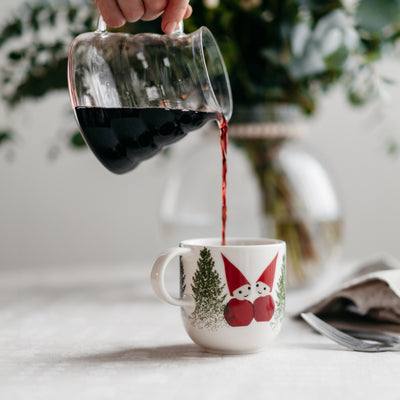 pouring coffee into aarikka tonttu mug