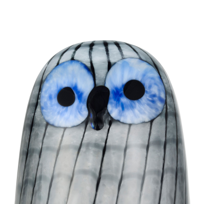 Glass figurine with striped pattern and large blue eyes on a white background