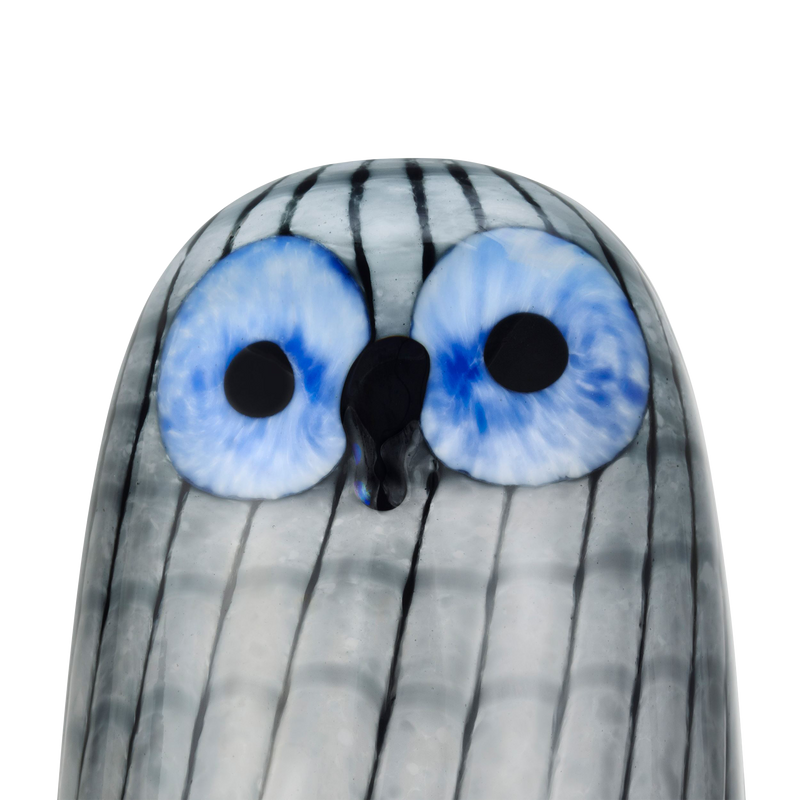 Glass figurine with striped pattern and large blue eyes on a white background