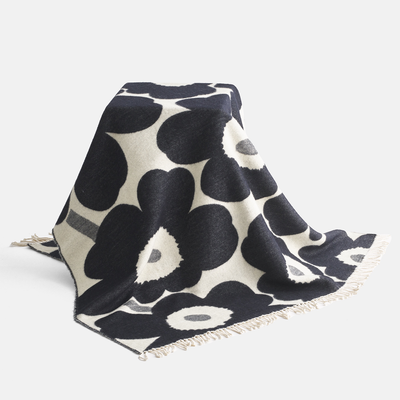 Marimekko charcoal unikko blanket draped over chair