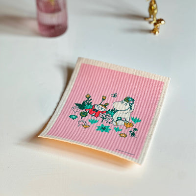 Pink striped towel with cartoon characters on a light surface