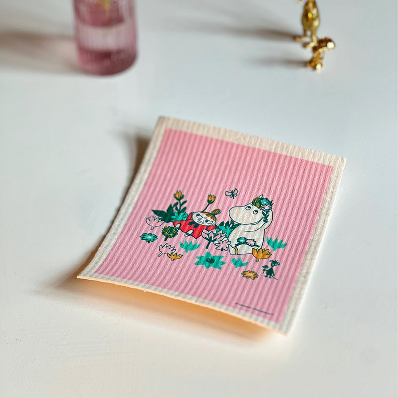 Pink striped towel with cartoon characters on a light surface