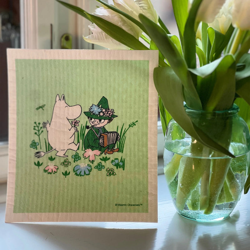 Illustration of a character and a bear with flowers on a green card, next to a vase with tulips.