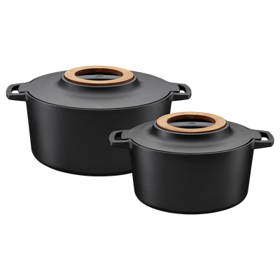 Two black cookware pots with wooden lids on a white background