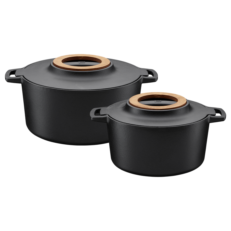 Two black cookware pots with wooden lids on a white background