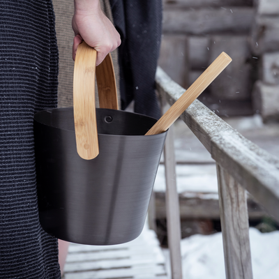 Holding Rento aluminum brown sauna bucket and ladle