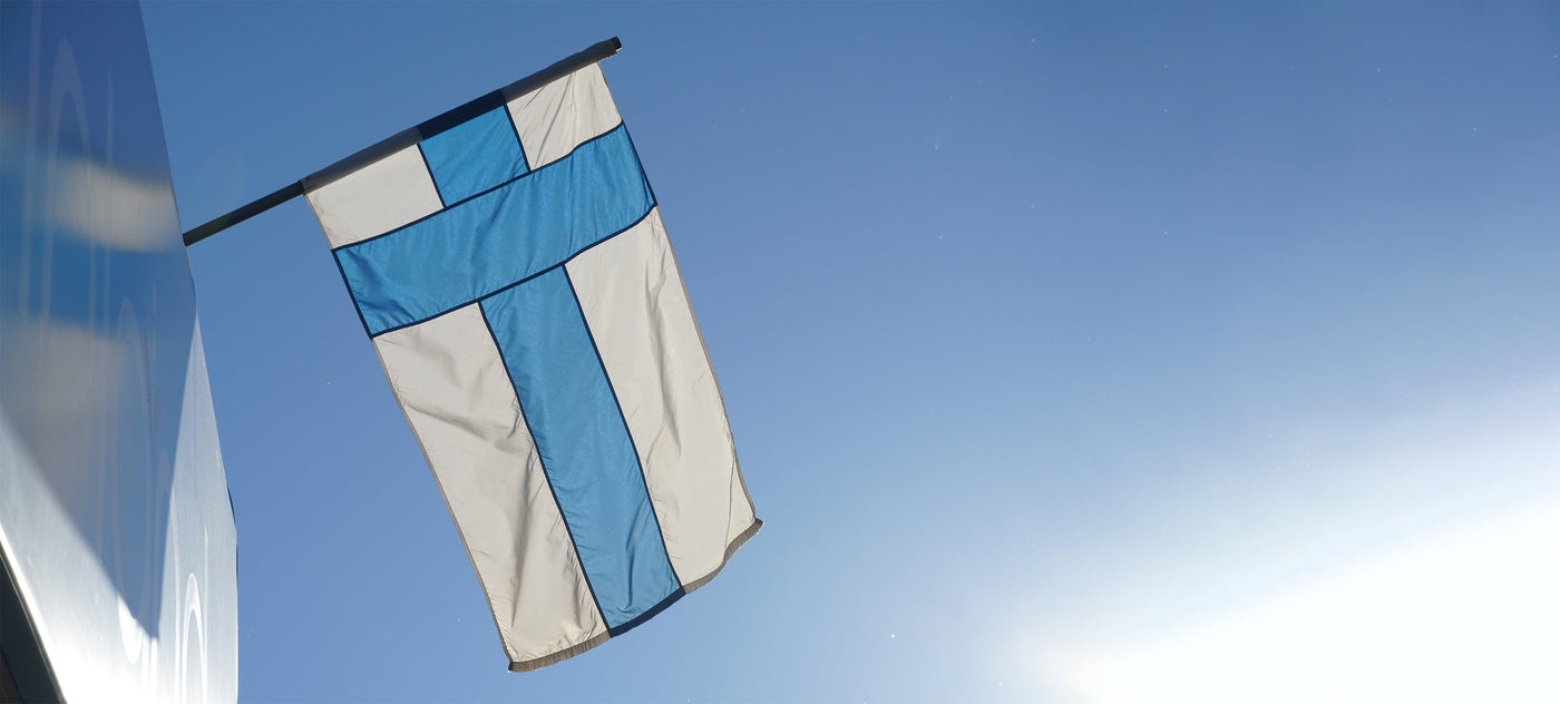 Finnish flag waving with blue sky in background