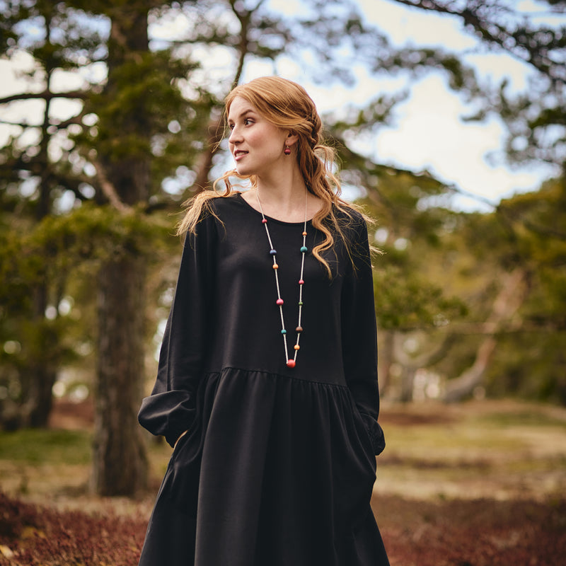 zoomed out view of model wearing Aarikka Värikimara Necklace, multicolor