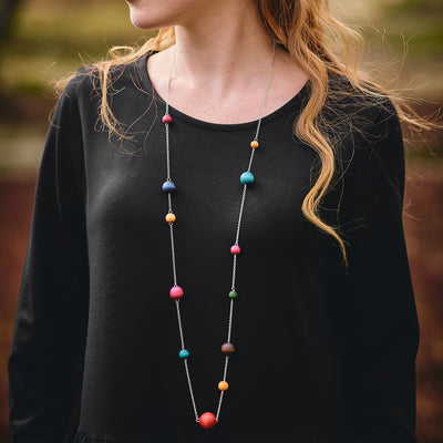 close up view of model wearing Aarikka Värikimara Necklace, multicolor