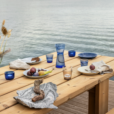 picnic table by lake with iittala kartio ultramarine table setting