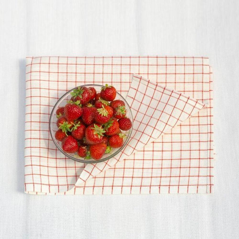 Folded Keittioruutu red striped towel with bowl of strawberries