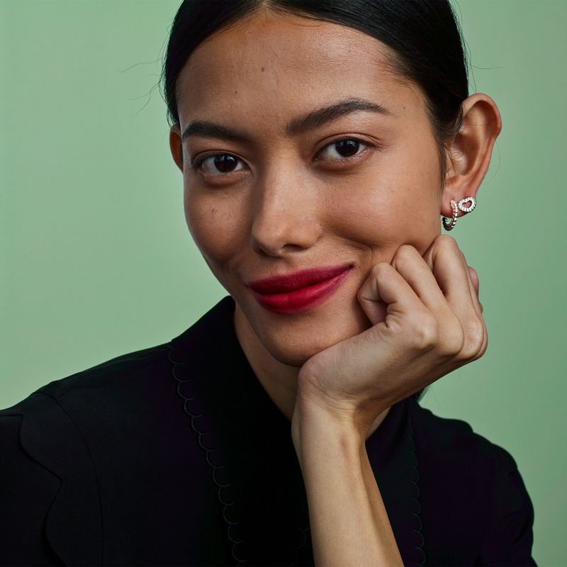 smiling woman wearing circle of light earrings