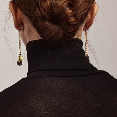 Behind a woman wearing Kosmos Bronze Earrings
