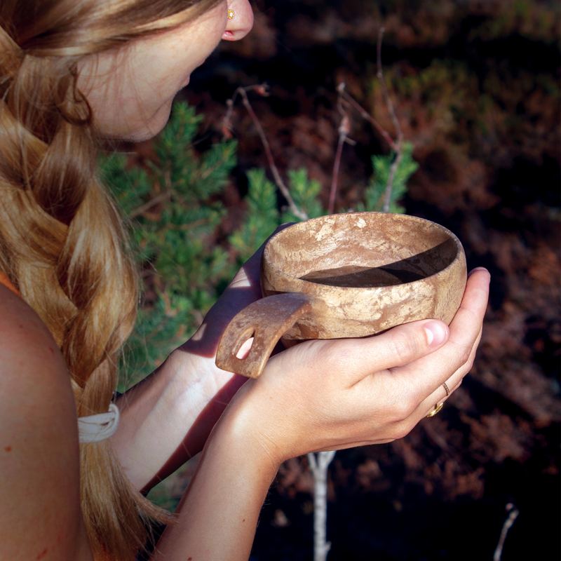 Woman holding Kupilka large cup in hands