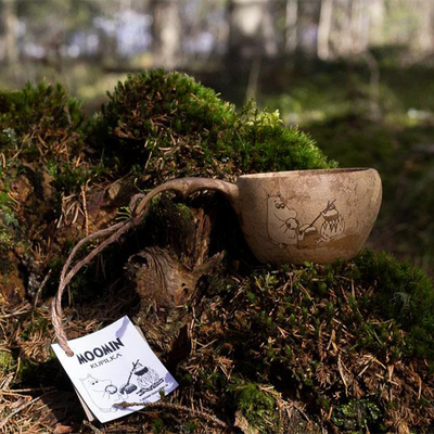 Kupilka Moomintroll Classic Cups sitting on moss mound in woods