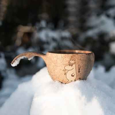 Kupilka Snorkmaiden Classic Cup sitting in snow