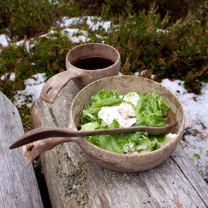 Lettuce salad in Kupilka bowl with coffee in Kupilka cup