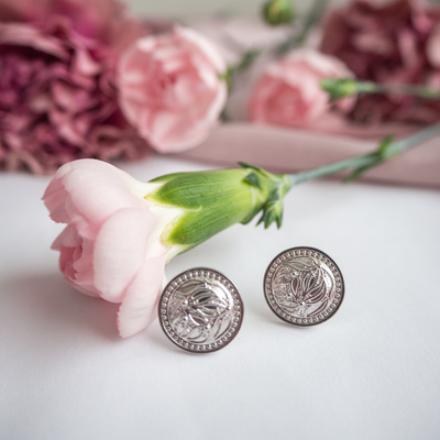 Lumoava Primavera Earrings placed on whiet table with roses