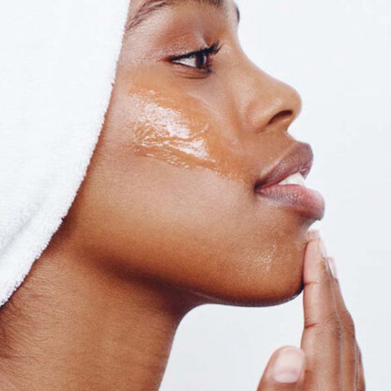Person applying Lumene Nordic-C Pure Glow Cleansing Balm to face