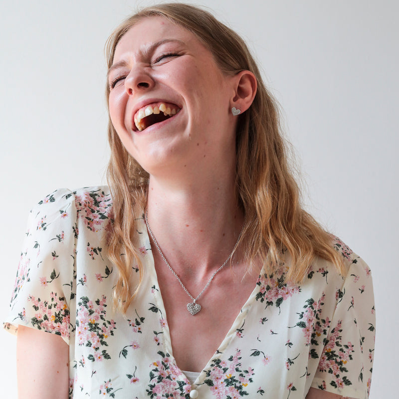 Woman laughing wearing a floral top and Lumoava Milky Way Necklace