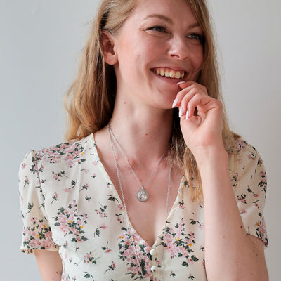 Laughing person wearing Lumoava Primavera Necklace