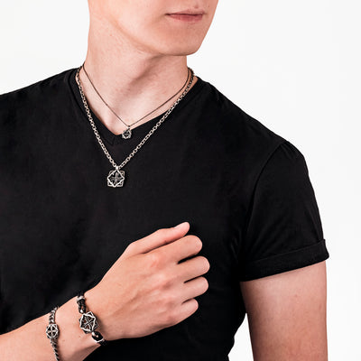 Man wearing warrior necklaces and bracelets in black t shirt