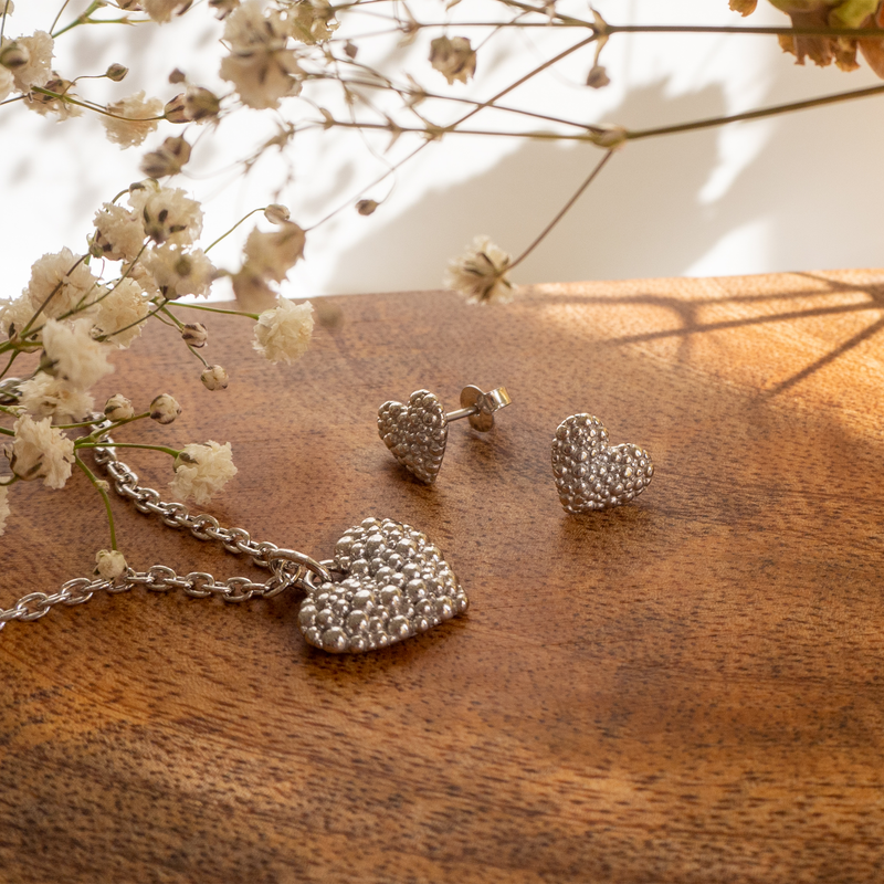 Lumoava Milky Way pendant and earrings laying on wood shelf