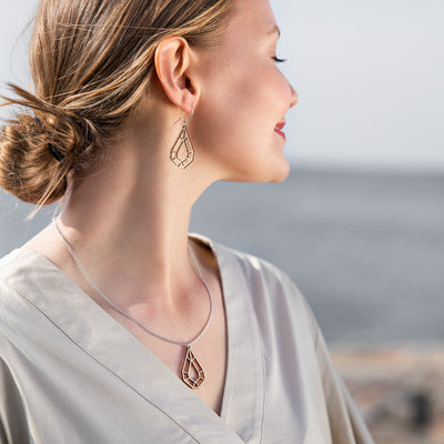 Woman modeling Valona Drop Birch jewelry at beach