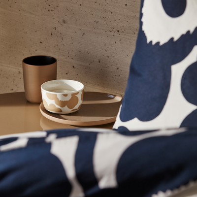 Display of Marimekko Unikko white/beige Dessert Bowl on neutral colored table