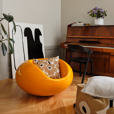 Living room with Marimekko cushion cover on orange chair