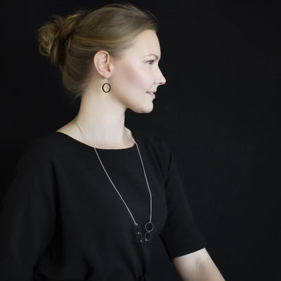 Woman modeling Valona Luna Birch jewelry in black top